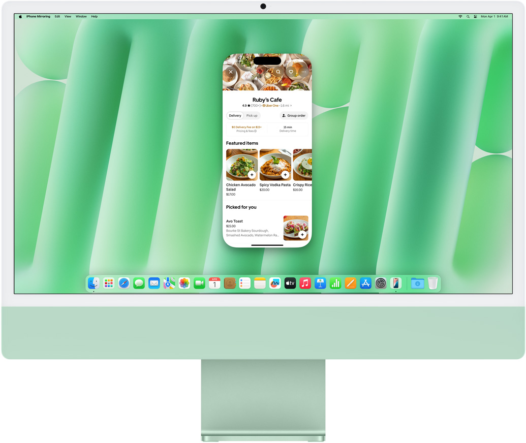 iPhone 鏡像輸出功能展示。顯示 Uber Eats app 的 iPhone 螢幕,在 iMac 上鏡像輸出並操作。