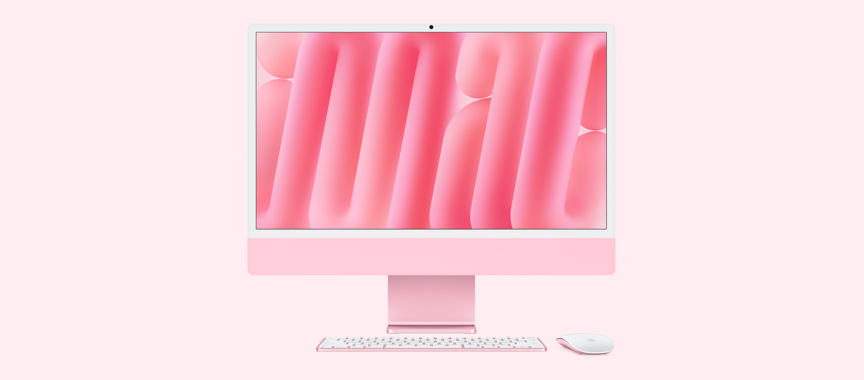 粉紅色 iMac 正面圖,展示同色系的滑鼠與鍵盤