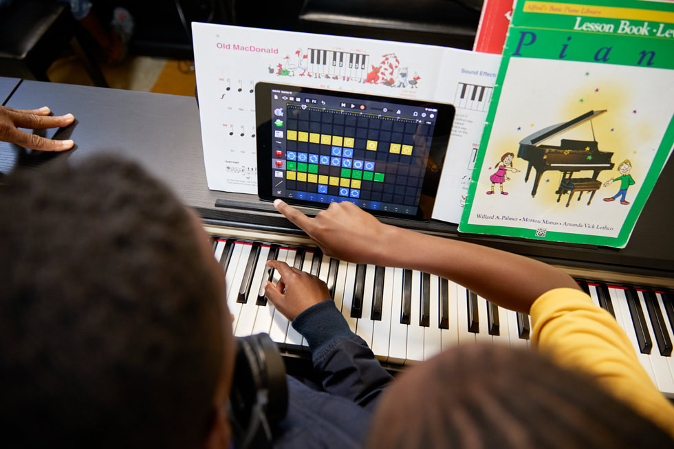 Students work with iPad at their piano in their piano class at the Ellis Marsalis Center.