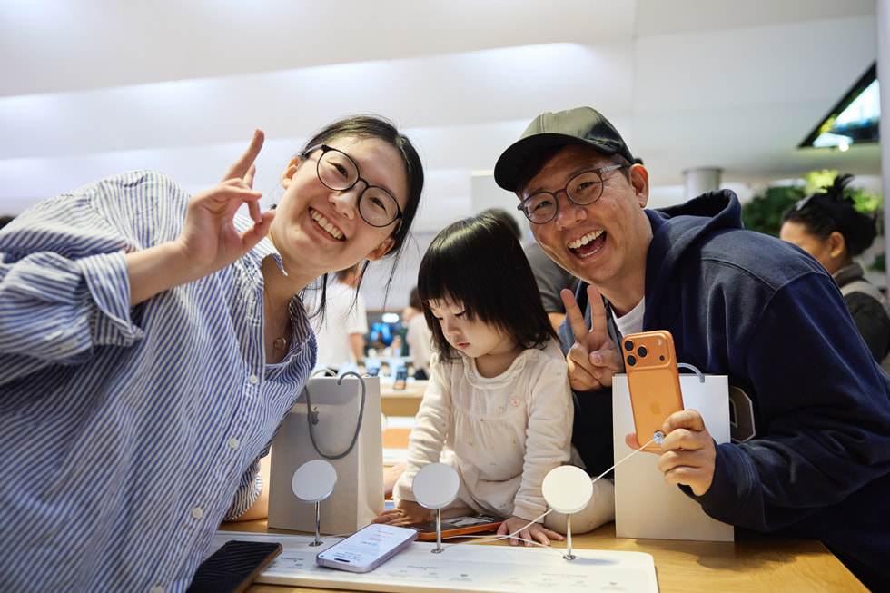 A family tests out the new iPhone 17 Pro with their toddler at Apple Fifth Avenue in New York.