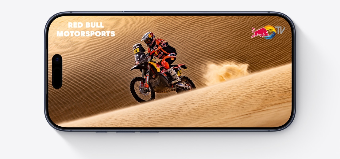 iPhone exterior față, dispus orizontal, pe ecran se prezintă un clip video din The Morning Show pe Apple TV+