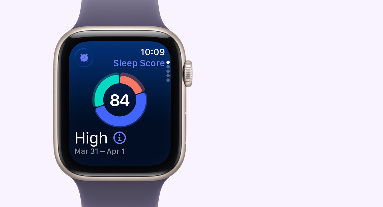 Apple Watch SE 3, алуминиев корпус, астро бял цвят, екранът показва кръгова диаграма с показател за сън, външна дясна страна, Digital Crown, Sport Band, цвят лилава мъгла