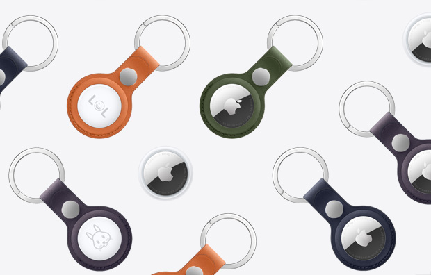 An array of AirTags and AirTags with FineWoven Key Ring in various colours including Orange, Dark Green, Deep Blue, Blackberry and Black